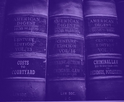 three old volumes of the law reference book "american record" tinted purple