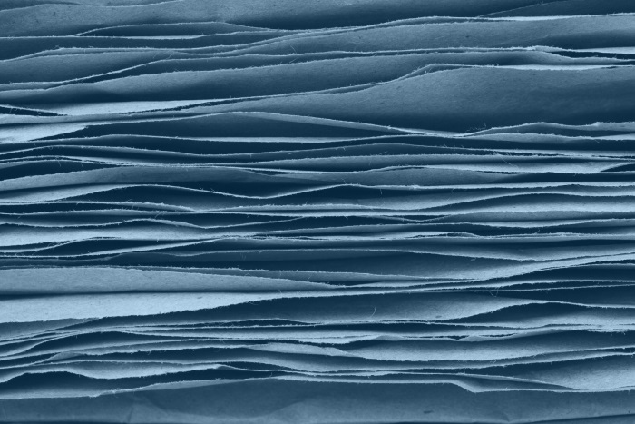 stack of natural fiber pages tinted blue